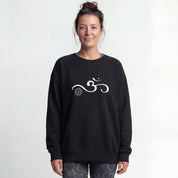 A person wearing a black yoga sweater with an Om symbol